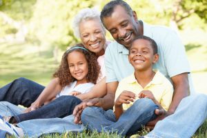 Smiling grandparents with grandchildren in a park