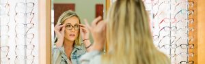 Girl trying on eyeglasses at Optical Shop